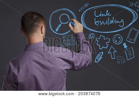 Business, Technology, Internet And Network Concept. A Young Businessman Writes On The Blackboard The