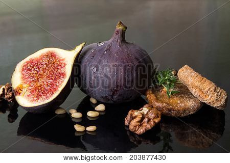 Figs, Dried Figs, Half Of Fig, Walnut And Pine Nuts On Black Background.