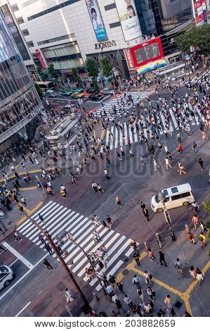 TOKYO, JAPAN JUNE 28 - 2017: Top view of crowd of people crossing in Shibuya street, one of the busiest crosswalks in the world, in the Ginza District in Tokyo, Japan.