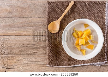 cooked casava in syrup serve with tiny cup of coconut milk.