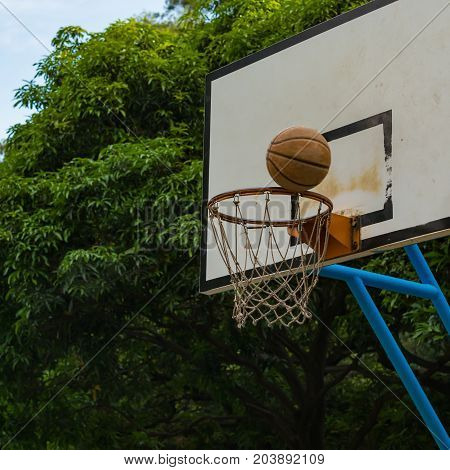 basketball on the rim of the hoop