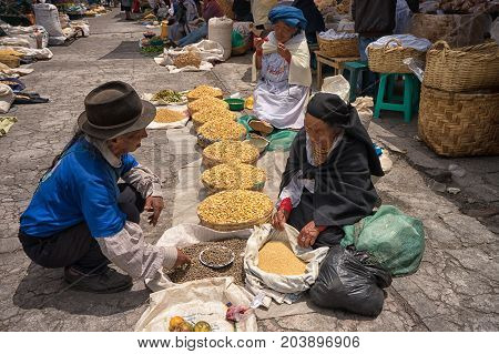 April 29 2017 Otavalo Ecuador: indigenous quechua people selling produce from the ground on the street in the Saturday market