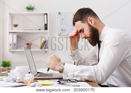 Thoughtful stressed frustrated man working for too long on computer, chooses solution, thinking about hard problem