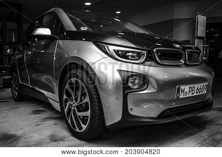 BERLIN - NOVEMBER 28 2014: Showroom. The BMW i3 previously Mega City Vehicle (MCV) is a five-door urban electric car developed by the German manufacturer BMW. Black and white.