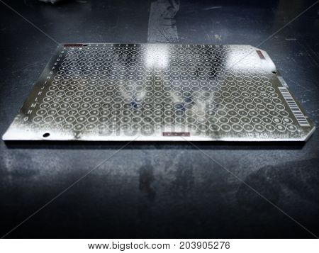 Dirty MALDI Mass spectrometer steel plate with 384 spots for high throughput screening of samples.