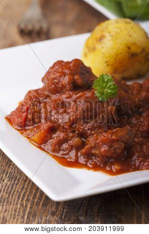 closeup of a hungarian goulash on wood