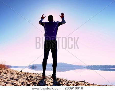 Jumping Man. Sportsman Crazy Jumping  And Jogging On Beach During The Sunrise