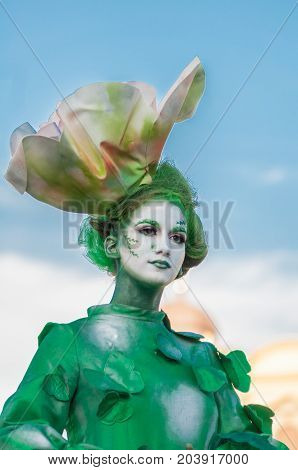 TIMISOARA, ROMANIA - September 08, 2017: Portrait of a woman in green dress at the CheckArt Carnaval. Living statue. Union Square.