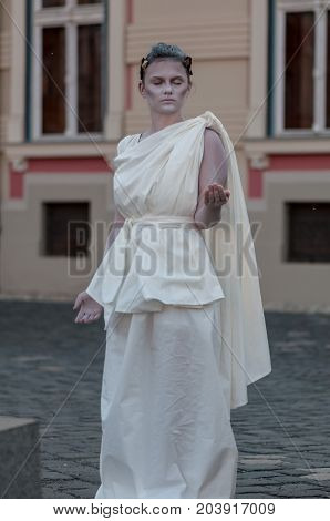 TIMISOARA, ROMANIA - September 08, 2017: Portrait of a woman in white dress at the CheckArt Carnaval. Living statue. Union Square.
