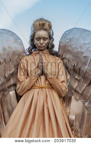 TIMISOARA, ROMANIA - September 08, 2017: Portrait of a woman in angel costume at the CheckArt Carnaval. Living statue. Union Square.