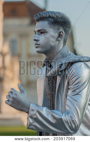 TIMISOARA, ROMANIA - September 08, 2017: Portrait of a man in silver costume at the CheckArt Carnaval. Living statue. Union Square.