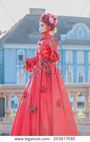 TIMISOARA, ROMANIA - September 08, 2017: Portrait of a woman in red dress at the CheckArt Carnaval. Living statue. Union Square.