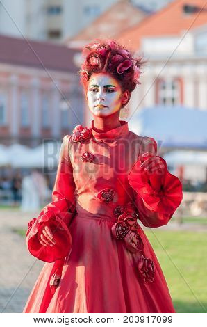 TIMISOARA, ROMANIA - September 08, 2017: Portrait of a woman in red dress at the CheckArt Carnival. Living statue. Union Square.