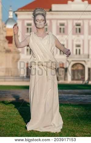 TIMISOARA, ROMANIA - September 08, 2017: Portrait of a woman in white dress at the CheckArt Carnival. Living statue. Union Square.