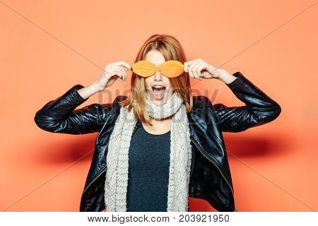 Woman With Autumn Leaves As Glasses In Leather Jacket.