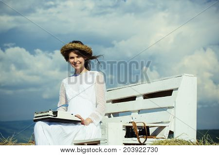 Happy Girl In Wreath And White Dress On Bench
