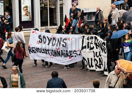 STRASBOURG FRANCE - SEPT 12 2017: Soyons Revolutionnaires translated as Be Revolutionary poster by incognito young people at French Nationwide day of protest against the labor reform proposed by Emmanuel Macron Government