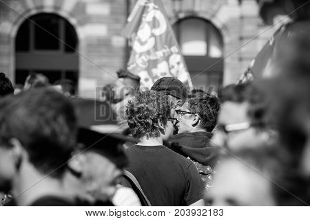 STRASBOURG FRANCE - SEPT 12 2017: Black and white demonstrators walk at political march during a French Nationwide day of protest against the labor reform proposed by Emmanuel Macron Government