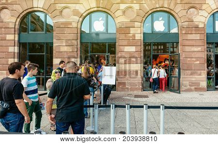 STRASBOURG FRANCE - SEP 20 2014: Customers waiting in line to pick-up their new reserved iPhone 7 from the Apple Store computer store selling iPad Apple Watch and iMac MacBook pro computers