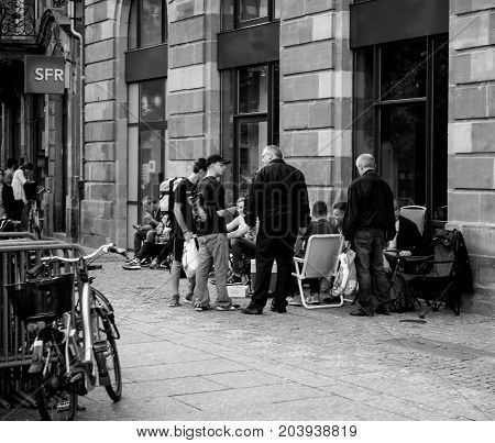 STRASBOURG FRANCE - SEP 9 2014: Customers waiting outside Apple Store prior the launch day of the newest iPhone Apple Watch iPad iMac computers - large Apple Store facade with computer Apple logotype