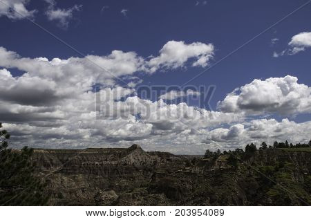 beautiful blue sky with white puffy clouds over Makoshika State Park in Montana