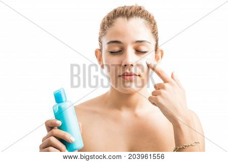 Woman Putting Some Cream On Her Face