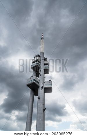 Prague, Czech Republic - August 21, 2017: Zizkov Television Tower in Prague. It is is a  transmitter tower and an example of high tech architecture. Low angle view a cloudy day of summer.