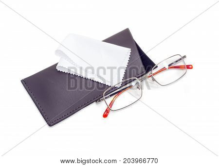 Modern pair of the classic men's eyeglasses in metal frame and soft spectacle-case with white wipes for glasses beside on a white background