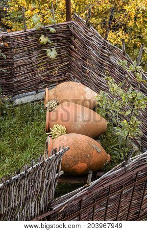 Old fence with jugs, Georgian color of autumn landscape