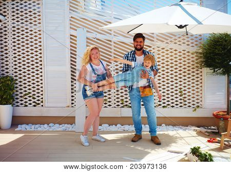 happy family setting up a trellis for plants on patio