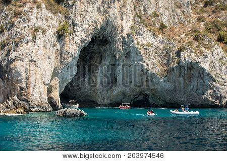 CAPRI ITALY - JUNE 13 2017: Boats with tourists near Grotta Bianca and Grotta Meravigliosa Capri iATLY
