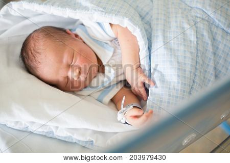 Newborn Baby Laying In Crib In Prenatal Hospital