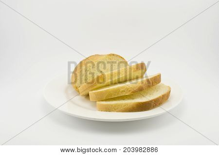 white bread figuratively sliced on a white plate