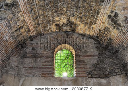 Window with a lattice in an old crypt.