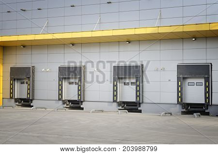 Detail of modern storage units building with sliding garage doors. Closed doors of the modern industrial storage warehouse.