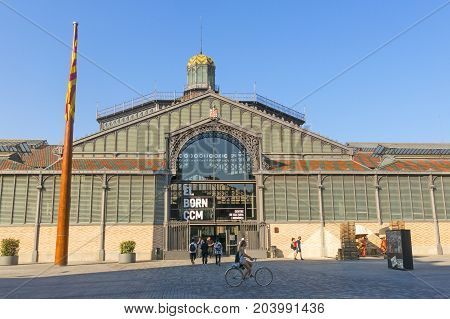 BARCELONA SPAIN - JUNE 1 2017: The facade of Born market and flag of Catalonia. It is an example of iron architecture a movement within the modernist. Born district. Barcelona Catalonia Spain