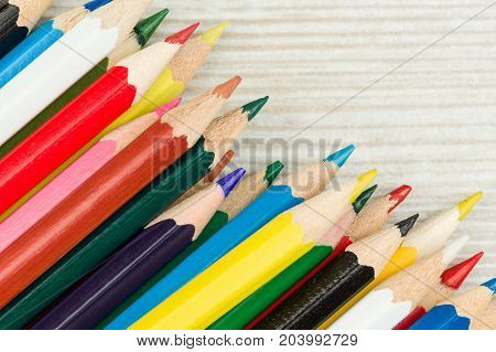 Colored pencils on a white table in left corner