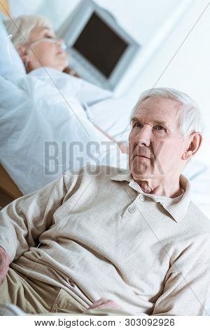 Sad Senior Man And Senior Woman In Coma In Hospital