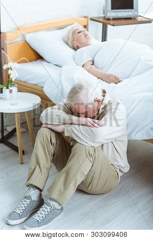 Sad Senior Man And Senior Woman In Coma In Hospital