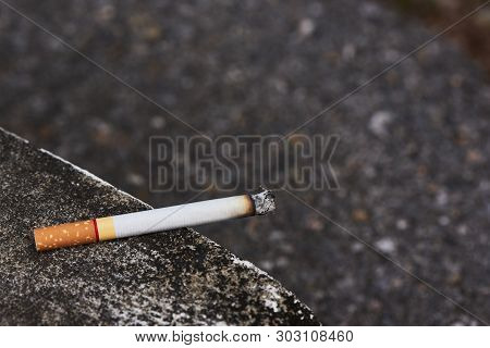 Close-up View Of A Cigarette Is Placed On The Edge Of The Mortar.