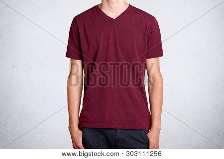 Studio Shot Of Casual Dark Red T Shirt, Presented Over White Background. Cotton Item Of Clothes Worn