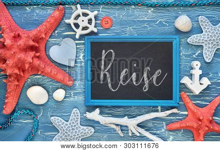 Blackboard With Maritime Decorations On Cracked Blue Wood, Text In German. 