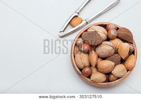 Different Kinds Of Nuts In The Shell, Hazelnut, Walnut, Almond And Brazil Nuts In A Bowl With Nut Cr