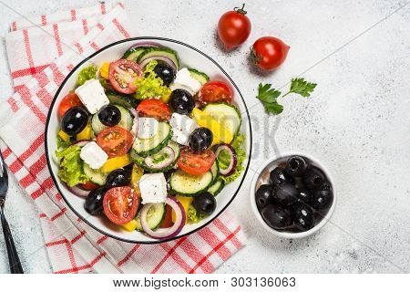 Greek Salad. Vegetable Salad From Tomato, Cucumber, Feta Cheese And Olive Oil On White Table. Top Vi