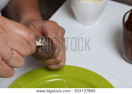 A Woman Decorates With The Help Of White Chocolate Popcake Glazed With Dark Chocolate.