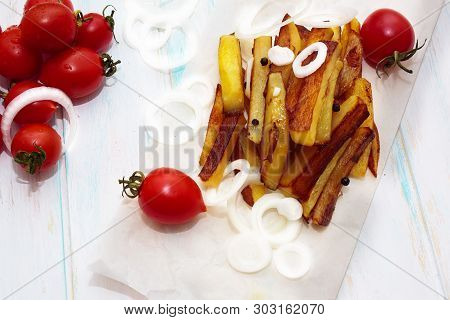 Home Made Potato Food With Tomatos Cherry And Onion On Kraft Paper . Baked Potatoes With Spices And
