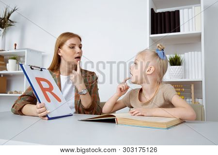 Speech Therapy Concept. Patient Kid With Female Therapist Training Pronunciation.