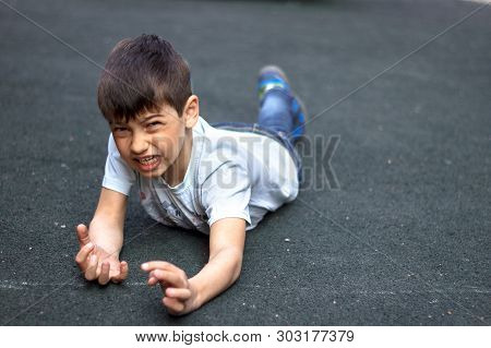 The Child Stumbled And Fell, Hit His Hand, The Boy Stumbled And Fell On The Sidewalk. Hes Hurting.