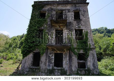 Ruined Overgrown Apartment House In Ghost Mining Town, Consequences Of War In Abkhazia, Green Post-a