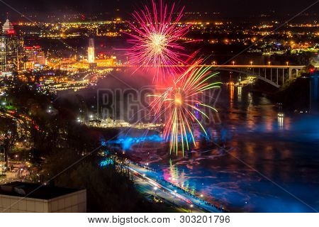 Niagara Falls, Canada - May 18-2019. Fireworks And Colorful Lights Illuminates The Waterfalls On Nia